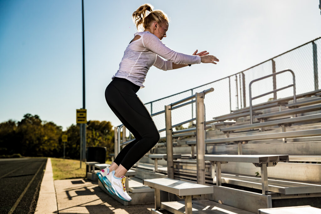 Kathryn Alexander, personal trainer in Austin, does bleacher jumps on an east side track